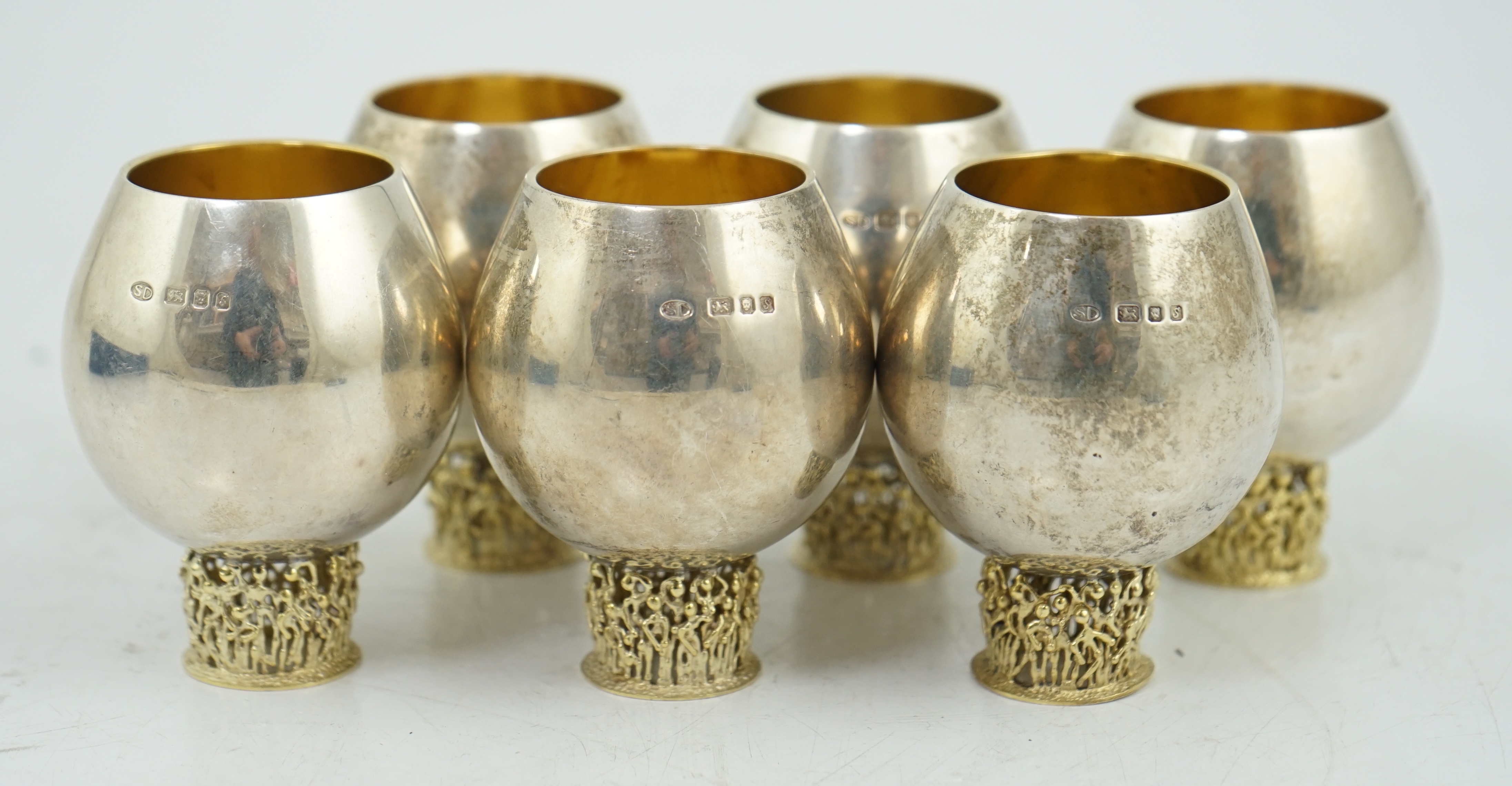 A set of six Elizabeth II Stuart Devlin parcel gilt silver balloon shaped pedestal tots